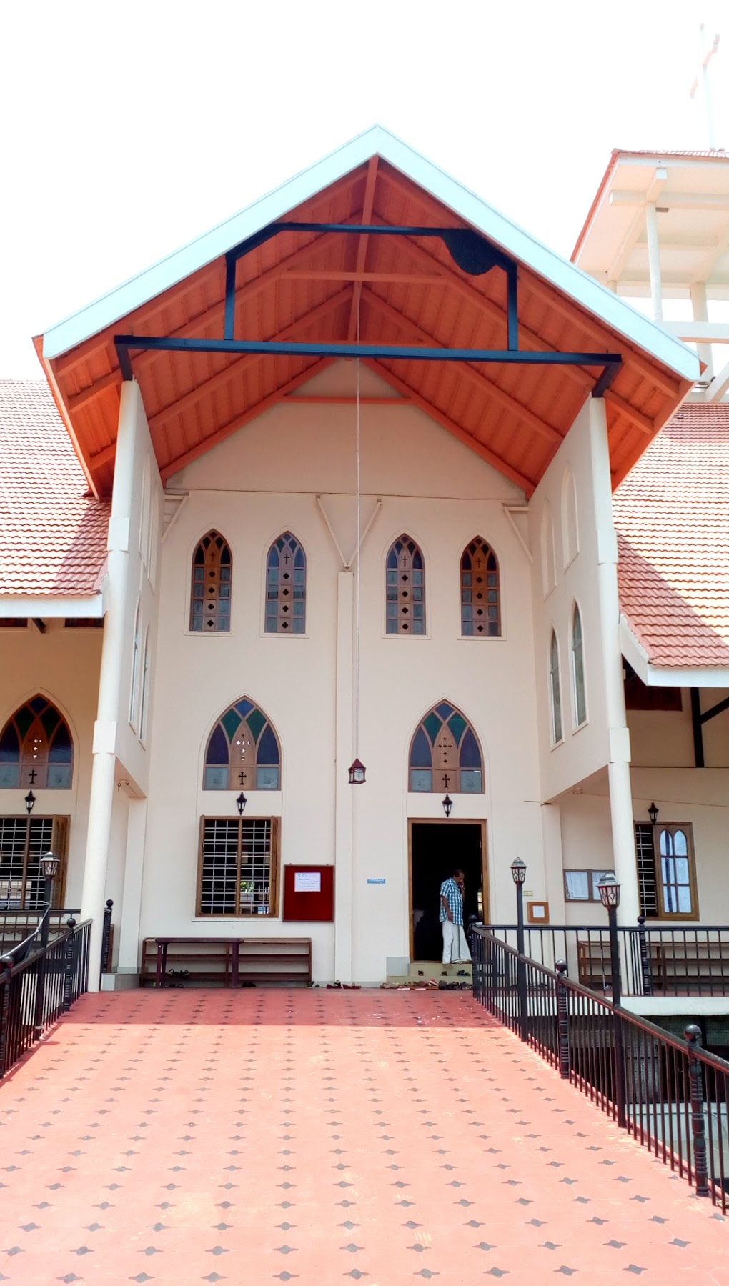 Front exterior of St Paul's Mar Thoma Church, Anchal with red tiled roof and arched windows